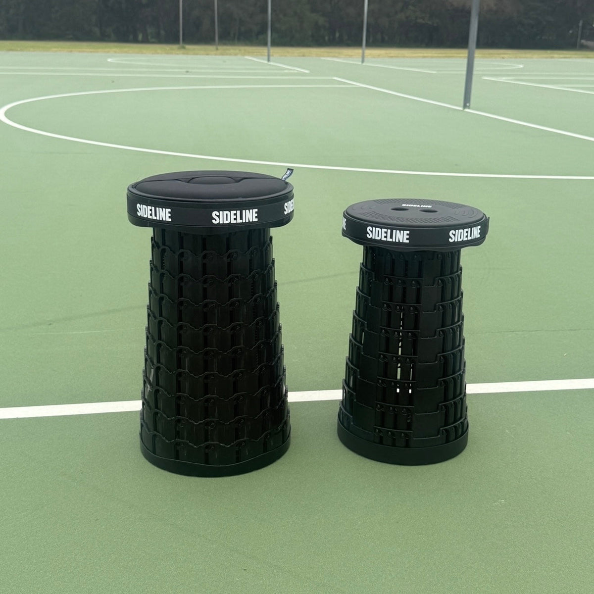 SIDELINE XL and Mini Luxe stools side by side on a sports field